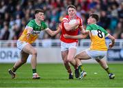 19 May 2025; Andrew O'Reilly of Louth in action against Charlie Duffy, left, and Eamon Maher of Offaly during the Electric Ireland Leinster GAA Football Minor Championship final match between Offaly and Louth at Cedral St Conleth's Park in Newbridge, Kildare. Photo by Piaras Ó Mídheach/Sportsfile
