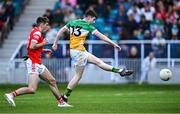 19 May 2025; Tony Furey of Offaly shoots to score his side's second goal, under pressure from Ciarán Titley of Louth, during the Electric Ireland Leinster GAA Football Minor Championship final match between Offaly and Louth at Cedral St Conleth's Park in Newbridge, Kildare. Photo by Piaras Ó Mídheach/Sportsfile