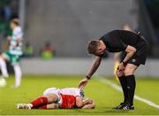 19 May 2025; Referee Damien MacGraith checks on the injured Brandon Kavanagh of St Patrick's Athletic during the SSE Airtricity Men's Premier Division match between Shamrock Rovers and St Patrick's Athletic at Tallaght Stadium in Dublin. Photo by Thomas Flinkow/Sportsfile