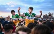19 May 2025; Stephen Byrne of Offaly, 18, is held aloft by supporters after victory in the Electric Ireland Leinster GAA Football Minor Championship final match between Offaly and Louth at Cedral St Conleth's Park in Newbridge, Kildare. Photo by Piaras Ó Mídheach/Sportsfile