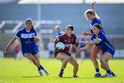 18 May 2025; Lucy Power of Westmeath in action against Laois players, from left, Eva Galvin, Ciara Burke and Ciara Crowley during the TG4 Leinster LGFA Intermediate Championship final match between Laois and Westmeath at TEG Cusack Park in Mullingar, Westmeath. Photo by Seb Daly/Sportsfile