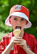 18 May 2025; Cork supporter Conor Casey, aged 8, from Donoughmore, Cork, enjoys an ice cream before the Munster GAA Hurling Senior Championship Round 4 match between Limerick and Cork at TUS Gaelic Grounds in Limerick. Photo by Sam Barnes/Sportsfile