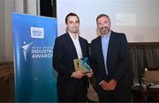 20 May 2025; Athletics Ireland Marketing and Communications Manager Darragh Brown, left, is presented with the Best Commerical Partnership in Sport by Dublin City sport and wellbeing partnership manager Colin Sharkey during the Irish Sport Industry Awards 2025 at College Green Hotel in Dublin. Photo by David Fitzgerald/Sportsfile
