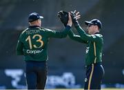 21 May 2025; Harry Tector of Ireland, left, celebrates with teammate Lorcan Tucker after running out Evin Lewis of West Indies during the first match of the One Day International Series between Ireland and the West Indies at Clontarf Cricket Club in Dublin. Photo by Sam Barnes/Sportsfile