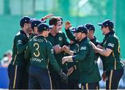 21 May 2025; Ireland bowler Tom Mayes, centre, celebrates with teammates after taking the wicket of Shai Hope of West Indies during the first match of the One Day International Series between Ireland and the West Indies at Clontarf Cricket Club in Dublin. Photo by Sam Barnes/Sportsfile