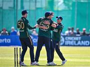 21 May 2025; Ireland bowler Tom Mayes, centre right, celebrates with teammates from left, George Dockrell, Andrew Balbirnie and Cade Carmichael after taking the wicket of Shai Hope of West Indies during the first match of the One Day International Series between Ireland and the West Indies at Clontarf Cricket Club in Dublin. Photo by Sam Barnes/Sportsfile