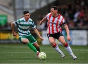 23 May 2025; Gavin Whyte of Derry City in action against Cory O'Sullivan of Shamrock Rovers during the SSE Airtricity Men's Premier Division match between Derry City and Shamrock Rovers at The Ryan McBride Brandywell Stadium in Derry. Photo by Stephen McCarthy/Sportsfile