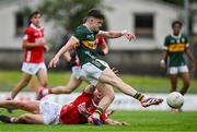 23 May 2025; Gearóid White of Kerry has a shot at goal despite the effort of Ben Coffey of Cork during the Electric Ireland Munster GAA Football Minor Championship final match between Kerry and Cork at Austin Stack Park in Tralee, Kerry. Photo by Brendan Moran/Sportsfile