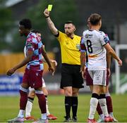 23 May 2025; Referee Declan Toland shows Elicha Ahui of Drogheda United a yellow card during the SSE Airtricity Men's Premier Division match between Drogheda United and Bohemians at Sullivan & Lambe Park in Drogheda, Louth. Photo by Shauna Clinton/Sportsfile