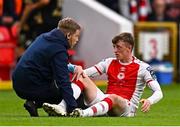 23 May 2025; Chris Forrester of St Patrick's Athletic receives medical treatment from St Patrick's Athletic head of medical Sam Rice during the SSE Airtricity Men's Premier Division match between St Patrick's Athletic and Waterford at Richmond Park in Dublin. Photo by Seb Daly/Sportsfile