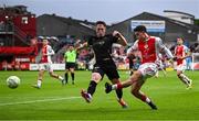 23 May 2025; Kian Leavy of St Patrick's Athletic in action against Sam Glenfield of Waterford during the SSE Airtricity Men's Premier Division match between St Patrick's Athletic and Waterford at Richmond Park in Dublin. Photo by Seb Daly/Sportsfile