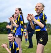 24 May 2025; Moate, Westmeath substitute players cheer on from the sidelines during the X Rugby 7s Girls match between Moate, Westmeath, and Fethard-Killusty, Tipperary, during day one of the Cairn Community Games Multi-Sports Finals 2025 at Gormanston Park in Meath. Photo by Shauna Clinton/Sportsfile