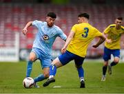 24 May 2025; Ciaran Paige of North End United is tackled by Brian Aherne of Fairview Rangers during the FAI Junior Cup final match between Fairview Rangers and North End United at Turner's Cross in Cork. Photo by Tom Beary/Sportsfile