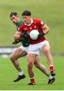 24 May 2025; Colm O'Callaghan of Cork in action against Seán Rafferty of Meath during the GAA Football All-Ireland Senior Championship Round 1 match between Meath and Cork at Páirc Tailteann in Navan, Meath. Photo by Thomas Flinkow/Sportsfile