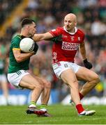24 May 2025; Donal Keogan of Meath in action against Matty Taylor of Cork during the GAA Football All-Ireland Senior Championship Round 1 match between Meath and Cork at Páirc Tailteann in Navan, Meath. Photo by Thomas Flinkow/Sportsfile
