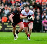 24 May 2025; Padraig McGrogan of Derry in action against Tiernan Kelly of Armagh during the GAA Football All-Ireland Senior Championship Round 1 match between Armagh and Derry at the BOX-IT Athletic Grounds in Armagh. Photo by Ray McManus/Sportsfile