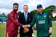 25 May 2025; West Indies captain Shai Hope, left, shakes hands with Ireland captain Paul Stirling, watched by match referee Dean Cosker, before match three of the One Day International Series between Ireland and the West Indies at Castle Avenue Cricket Ground in Dublin. Photo by Seb Daly/Sportsfile