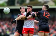 24 May 2025; Conor Doherty of Derry is taackled by Barry McCambridge and Oisin Conaty of Armagh, 12, during the GAA Football All-Ireland Senior Championship Round 1 match between Armagh and Derry at the BOX-IT Athletic Grounds in Armagh. Photo by Ray McManus/Sportsfile