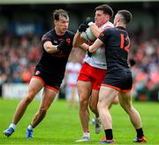 24 May 2025; Conor Doherty of Derry is taackled by Barry McCambridge and Oisin Conaty of Armagh, 12, during the GAA Football All-Ireland Senior Championship Round 1 match between Armagh and Derry at the BOX-IT Athletic Grounds in Armagh. Photo by Ray McManus/Sportsfile