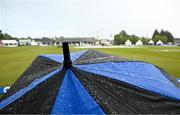 25 May 2025; Rain drops on an umbrella as rain stops play during match three of the One Day International Series between Ireland and the West Indies at Castle Avenue Cricket Ground in Dublin. Photo by Seb Daly/Sportsfile