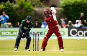 25 May 2025; West Indies batter Shai Hope plays a shot, watched by Ireland wicketkeeper Lorcan Tucker, during match three of the One Day International Series between Ireland and the West Indies at Castle Avenue Cricket Ground in Dublin. Photo by Seb Daly/Sportsfile