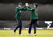 25 May 2025; George Dockrell of Ireland, left, celebrates with teammate Andrew Balbirnie after taking the wicket of West Indies batter Shai Hope during match three of the One Day International Series between Ireland and the West Indies at Castle Avenue Cricket Ground in Dublin. Photo by Seb Daly/Sportsfile