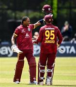 25 May 2025; West Indies batter Keacy Carty, left, celebrates after scoring a century of runs during match three of the One Day International Series between Ireland and the West Indies at Castle Avenue Cricket Ground in Dublin. Photo by Seb Daly/Sportsfile