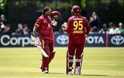 25 May 2025; West Indies batter Keacy Carty, left, celebrates after scoring a century of runs during match three of the One Day International Series between Ireland and the West Indies at Castle Avenue Cricket Ground in Dublin. Photo by Seb Daly/Sportsfile