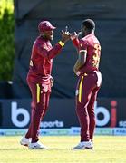 25 May 2025; West Indies bowler Jayden Seales, right, celebrates with teammate Matthew Forde after dismissing Ireland batter Andrew Balbirnie during match three of the One Day International Series between Ireland and the West Indies at Castle Avenue Cricket Ground in Dublin. Photo by Seb Daly/Sportsfile