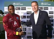 25 May 2025; Keacy Carty of West Indies is presented with the Player of the Match and Player of the Series awards by Chair of the Cricket Ireland Board Brian MacNeice after match three of the One Day International Series between Ireland and the West Indies at Castle Avenue Cricket Ground in Dublin. Photo by Seb Daly/Sportsfile