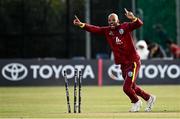 25 May 2025; West Indies bowler Roston Chase celebrates the wicket of Ireland batter Barry McCarthy, run-out by teammate Justin Greaves, not pictured, during match three of the One Day International Series between Ireland and the West Indies at Castle Avenue Cricket Ground in Dublin. Photo by Seb Daly/Sportsfile