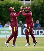 25 May 2025; Evin Lewis of West Indies, right, celebrates with teammate Keacy Carty after running-out Ireland batter Andrew McBrine, not pictured, to claim victory for his side in match three of the One Day International Series between Ireland and the West Indies at Castle Avenue Cricket Ground in Dublin. Photo by Seb Daly/Sportsfile