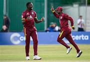 25 May 2025; Evin Lewis of West Indies, right, celebrates after running-out Ireland batter Andrew McBrine, not pictured, to claim victory for his side in match three of the One Day International Series between Ireland and the West Indies at Castle Avenue Cricket Ground in Dublin. Photo by Seb Daly/Sportsfile