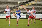 25 May 2025; John Donohoe of Cavan in action against Ciaran McCrystal of Tyrone during the Electric Ireland Ulster GAA Football Minor Championship final match between Cavan and Tyrone at Brewster Park in Enniskillen, Fermanagh. Photo by Oliver McVeigh/Sportsfile