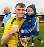 24 May 2025; Cian McNamara of Fairview Rangers celebrates with his nephew Billy Fitzgerald after his side's victory in the FAI Junior Cup final match between Fairview Rangers and North End United at Turner's Cross in Cork. Photo by Tom Beary/Sportsfile