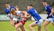 25 May 2025; Peter Colton in action against Andrew Smart of Cavan  during the Electric Ireland Ulster GAA Football Minor Championship final match between Cavan and Tyrone at Brewster Park in Enniskillen, Fermanagh. Photo by Oliver McVeigh/Sportsfile