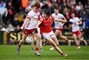 28 May 2025; Conall Sheehy of Tyrone is tackled by Tadgh McDonell of Louth during the Dalata Hotel Group GAA Football All-Ireland U20 Championship final match between Louth and Tyrone at BOX-IT Athletic Grounds in Armagh. Photo by Seb Daly/Sportsfile