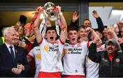 28 May 2025; Tyrone captain Joey Clarke, left, lifts the trophy alongside team-mate Eoin McElholm after their side's victory in the Dalata Hotel Group GAA Football All-Ireland U20 Championship final match between Louth and Tyrone at BOX-IT Athletic Grounds in Armagh. Photo by Oliver McVeigh/Sportsfile
