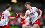 28 May 2025; Joey Clarke of Tyrone, right, is congratulated by teammate Noah Grimes after kicking a point during the Dalata Hotel Group GAA Football All-Ireland U20 Championship final match between Louth and Tyrone at BOX-IT Athletic Grounds in Armagh. Photo by Seb Daly/Sportsfile