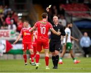 30 May 2025; John Martin of Shelbourne is shown a yellow card by referee Marc Lynch during the SSE Airtricity Men's Premier Division match between Cork City and Shelbourne at Turner's Cross in Cork. Photo by Michael P Ryan/Sportsfile