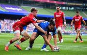 31 May 2025; James Lowe of Leinster scores his side's first try despite the efforts of Arhie Hughes of Scarlets during the United Rugby Championship quarter-final match between Leinster and Scarlets at the Aviva Stadium in Dublin. Photo by Brendan Moran/Sportsfile
