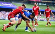 31 May 2025; James Lowe of Leinster scores his side's first try despite the efforts of Arhie Hughes of Scarlets during the United Rugby Championship quarter-final match between Leinster and Scarlets at the Aviva Stadium in Dublin. Photo by Brendan Moran/Sportsfile