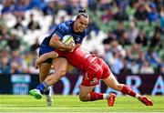31 May 2025; James Lowe of Leinster is tackled by Sam Costelow of Scarlets during the United Rugby Championship quarter-final match between Leinster and Scarlets at the Aviva Stadium in Dublin. Photo by Seb Daly/Sportsfile