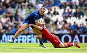 31 May 2025; James Lowe of Leinster is tackled by Sam Costelow of Scarlets during the United Rugby Championship quarter-final match between Leinster and Scarlets at the Aviva Stadium in Dublin. Photo by Seb Daly/Sportsfile