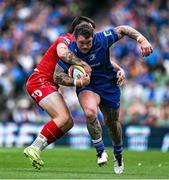 31 May 2025; Andrew Porter of Leinster is tackled by Joe Roberts of Scarlets during the United Rugby Championship quarter-final match between Leinster and Scarlets at the Aviva Stadium in Dublin. Photo by Brendan Moran/Sportsfile