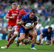 31 May 2025; James Lowe of Leinster is tackled by Josh Macleod of Scarlets during the United Rugby Championship quarter-final match between Leinster and Scarlets at the Aviva Stadium in Dublin. Photo by Brendan Moran/Sportsfile