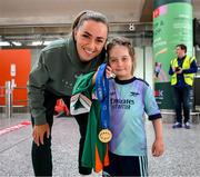 31 May 2025; Republic of Ireland's Katie McCabe shows her UEFA Women's Champions League winners medal to Republic of Ireland and Arsenal supporter Georgie Ring, age 5, from Carrigaline, Cork, on the team's arrival at Cork International Airport ahead of their UEFA Women's Nations League match against Slovenia at Páirc Uí Chaoimh in Cork on Tuesday. Photo by Stephen McCarthy/Sportsfile