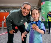 31 May 2025; Republic of Ireland's Katie McCabe shows her UEFA Women's Champions League winners medal to Republic of Ireland and Arsenal supporter Georgie Ring, age 5, from Carrigaline, Cork, on the team's arrival at Cork International Airport ahead of their UEFA Women's Nations League match against Slovenia at Páirc Uí Chaoimh in Cork on Tuesday. Photo by Stephen McCarthy/Sportsfile
