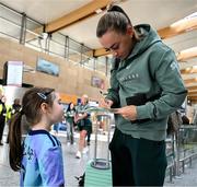 31 May 2025; Republic of Ireland's Katie McCabe with Georgie Ring, age 5, from Carrigaline, Cork, on the team's arrival at Cork International Airport ahead of their UEFA Women's Nations League match against Slovenia at Páirc Uí Chaoimh in Cork on Tuesday. Photo by Stephen McCarthy/Sportsfile