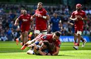 31 May 2025; Hugo Keenan of Leinster scores his side's fourth try, despte the tackle to Scarlets players Johnny Williams and Blair Murray, during the United Rugby Championship quarter-final match between Leinster and Scarlets at the Aviva Stadium in Dublin. Photo by Seb Daly/Sportsfile